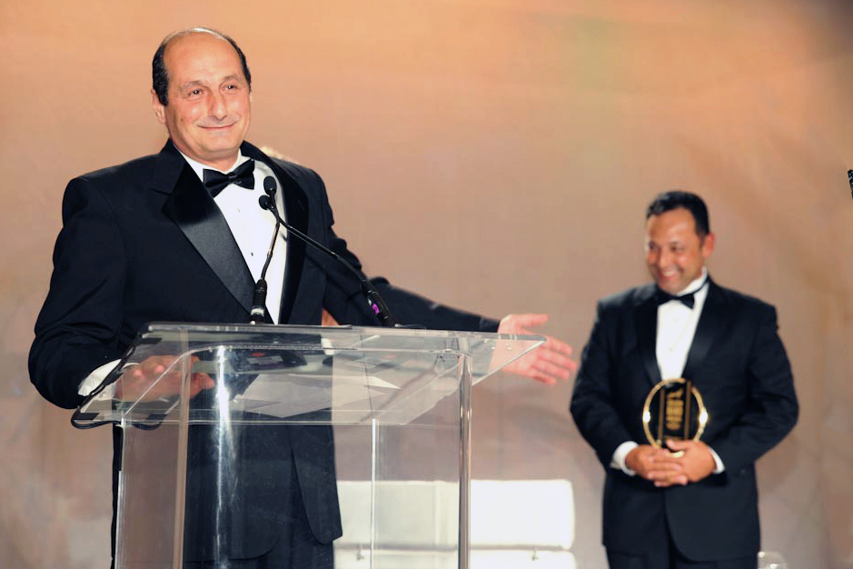 Davidoff Appointed Merchants | Ammar Tabbaa, owner of Maxamar Ultimate Cigars, accepting the Appointed Merchant award at the Golden Band Awards ceremony in 2013. Eliseo Gonzalez, a sales manager for Davidoff, is in the background.